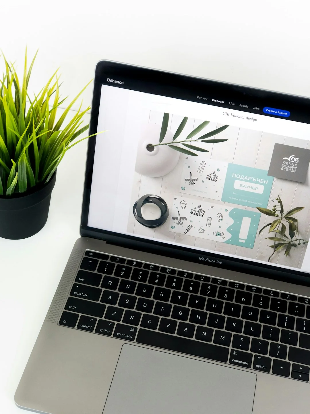 A miniature shopping cart with a parcel on a laptop symbolizes online shopping and e-commerce.